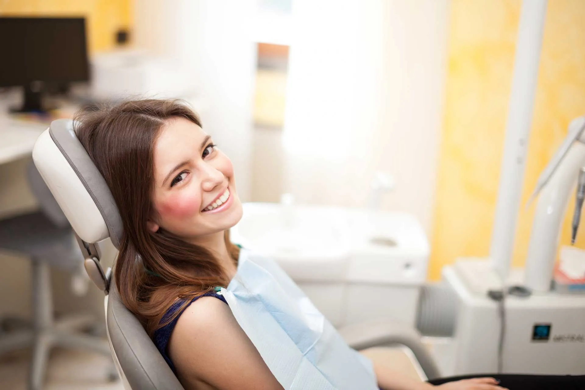 A smiling patient in the dental chair